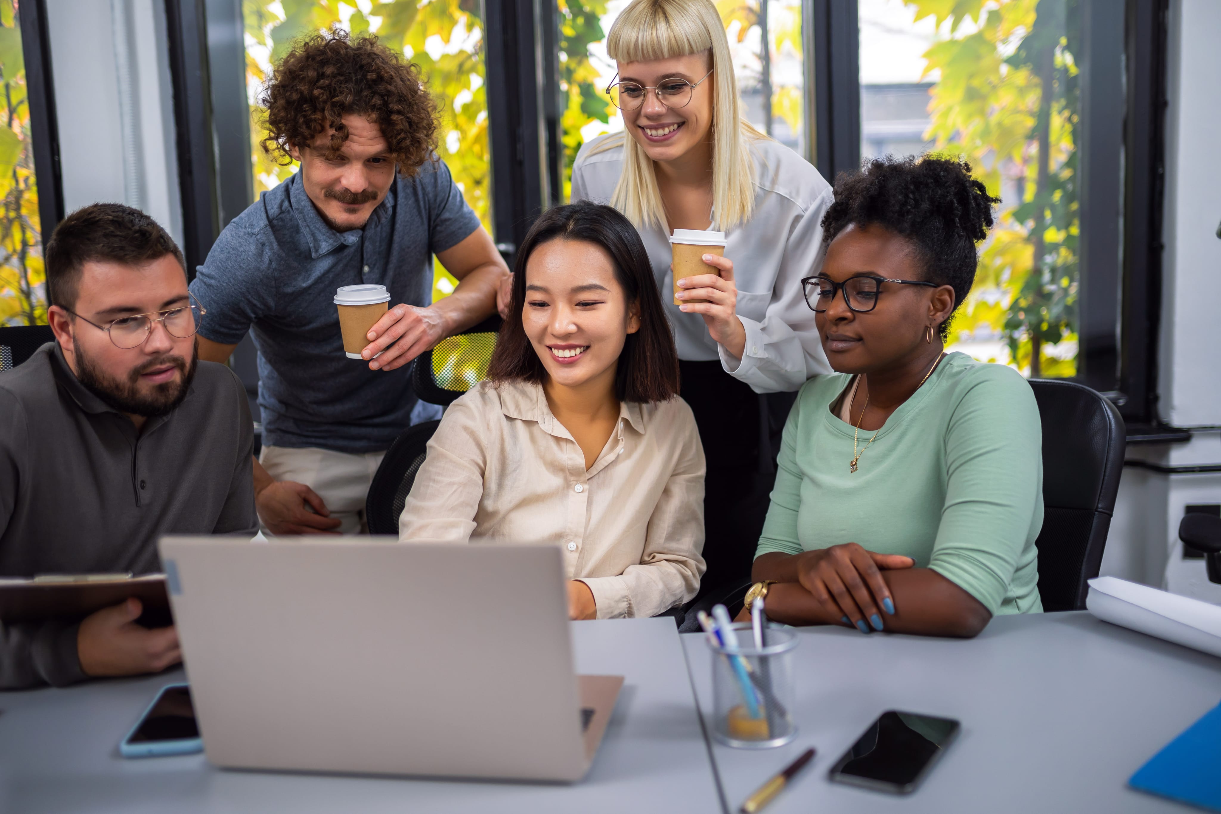 group of educators working around laptop